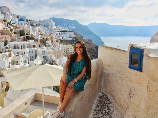 Marisa sitting above Santorini